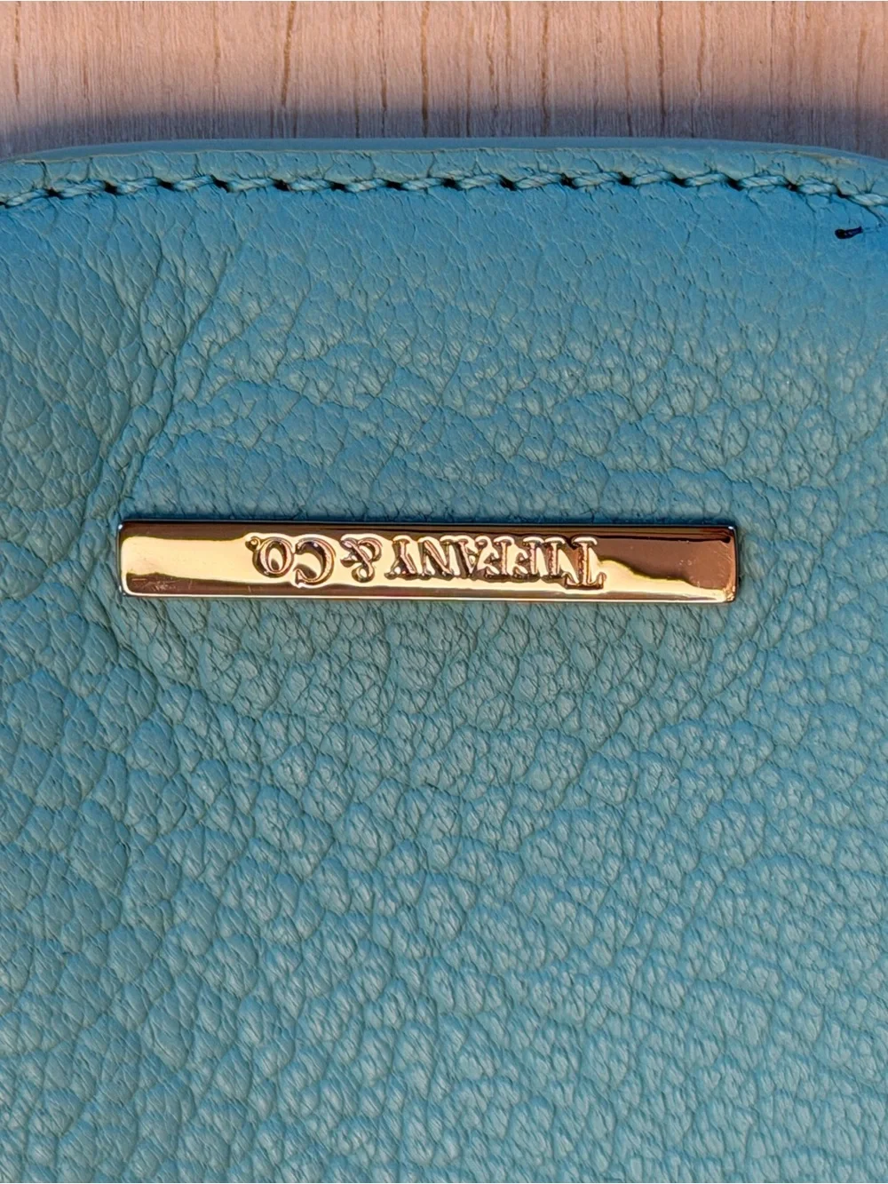 Tiffany & Co. turquoise pebbled leather phone sleeve with gold logo